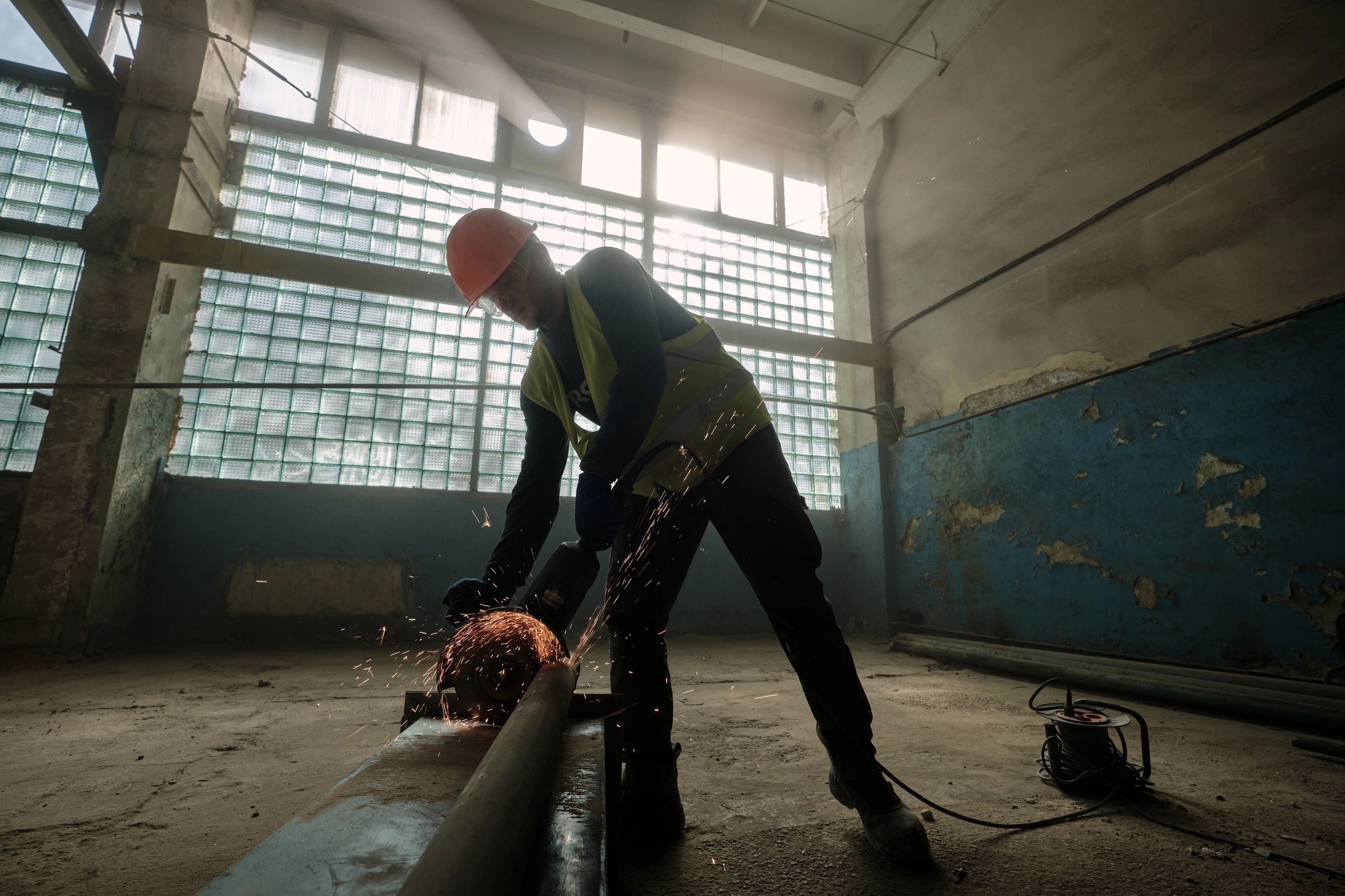 Professional worker cutting material with an electric saw