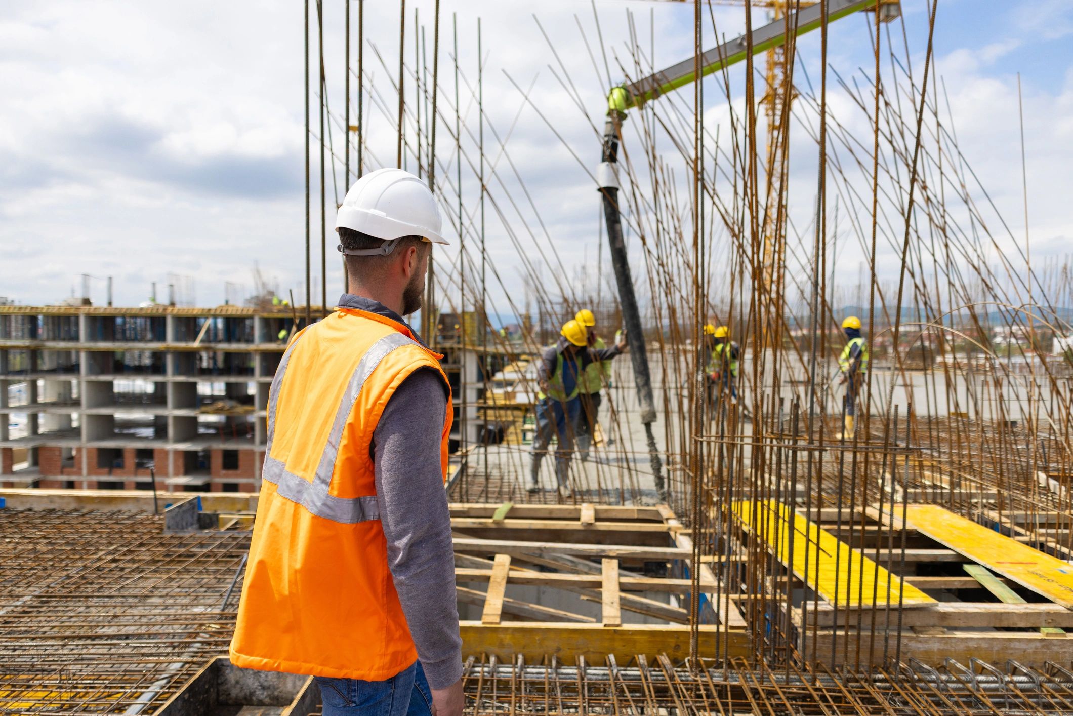 Engineer supervising construction workers on a job site