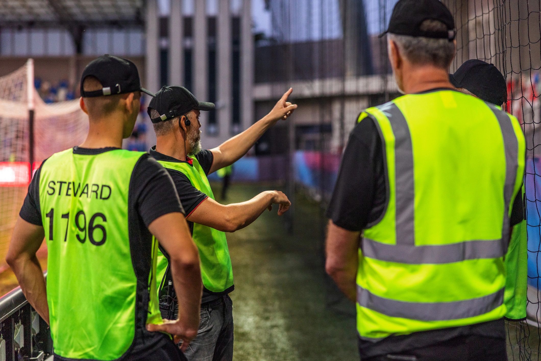 Two workers in reflective vests on a site