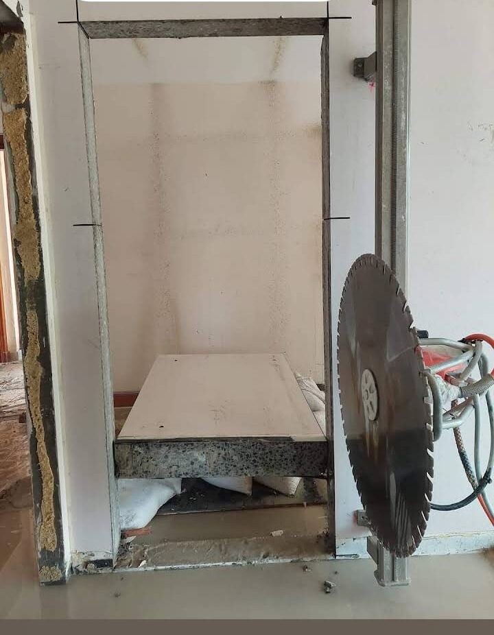 Workers preparing an interior wall area for cutting and installation